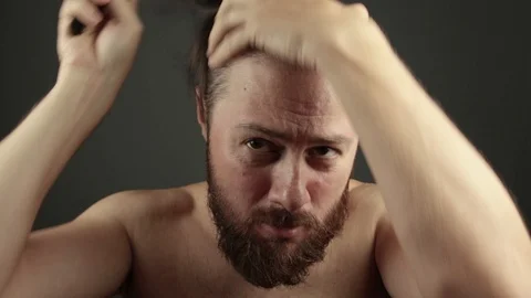 Man just after shower brushing his hair and beard Stock Footage 93079253