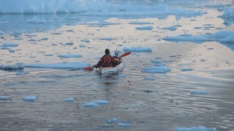 Man in a kayak moving alone in the middle of the Arctic Ocean, Greenland Stock Footage 100872047