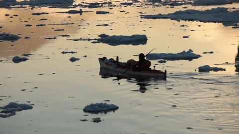 Man in a kayak moving alone in the middle of the Arctic Ocean, Greenland Video stock 100872342