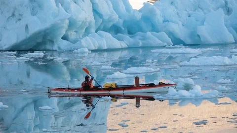 Man in a kayak moving alone in the middle of the Arctic Ocean, Greenland Video stock 100872405
