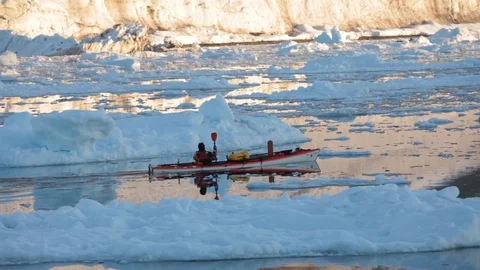 Man in a kayak moving alone in the middle of the Arctic Ocean, Greenland Video stock 100872464