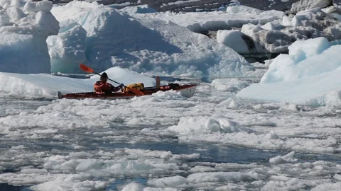 Man in a kayak moving alone in the middle of the Arctic Ocean, Greenland Stock Footage 100872591