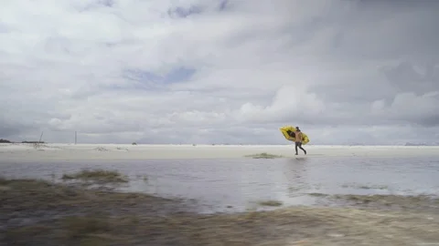 Man with kayak walking on the beach Stock Footage 86176814