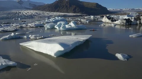 Man kayaking in muddy glacier Stock Footage 74907364