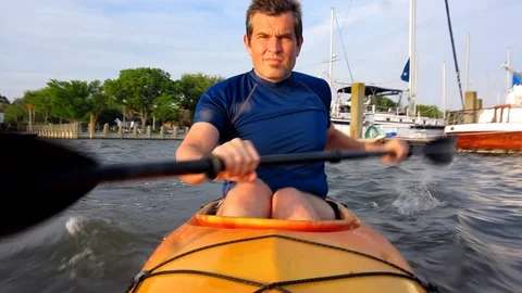 Man Kayaking on open water, view from front Stock Footage 87878446