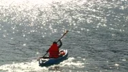 Man Kayaking On Sea Near Island Stock Footage