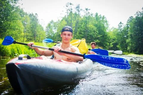 Man kayaking in wild river Stock Photos