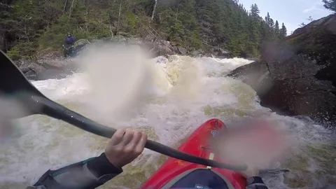 A man kayaks down a waterfall on a river. Stock Footage