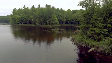 Man Kayaks into Open Lake Stock Footage 75797682