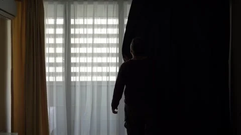 Man keep the curtains closed and blocks light in dusk hotel room Stock Footage 238525199