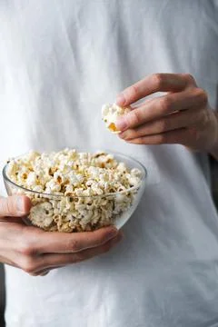 Man keep popcorn close-up Stock Photos