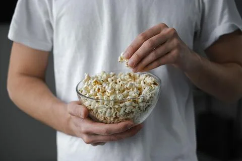 Man keep popcorn close-up Stock Photos