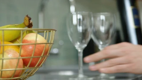Man keep wine bottle and glasses on the table in kitchen Stock Footage 111971654