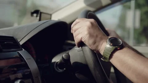Man keeping hand on the steering wheel, closeup. Safety and attention on the Stock-Footage 336266764