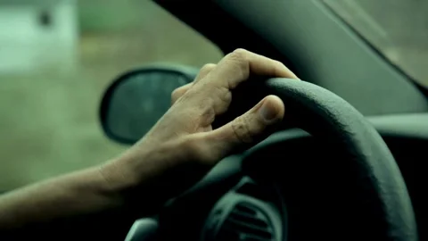 Man keeping hand on the steering wheel, closeup. Safety and attention on the Stock-Footage 336267124