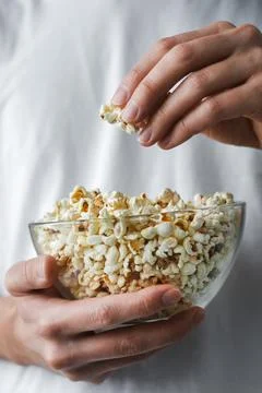 Man keeping popcorn close-up Stock Photos