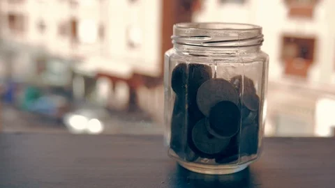 A man keeps coins in a glass jar Stock Footage 101460720