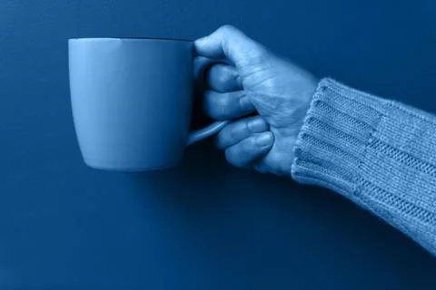 Man keeps green mug Stock Photos