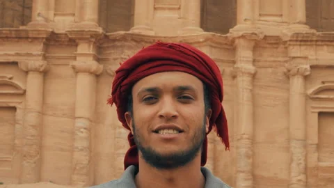 Man with Keffiyeh Looking At Camera in front of Petra Stock Footage 271586600