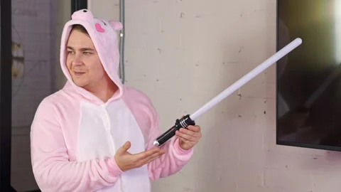 Man in kigurumi with sword speaker present video game , creative ad promotion Stock Footage 284783716