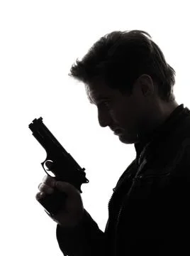 Man killer policeman holding gun portrait silhouette Stock Photos