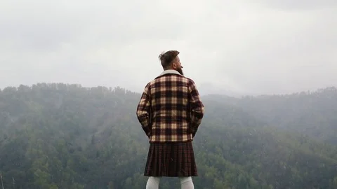 Man kilt with mustache beard mountain. looking back. snow. fog Caucasian Stock Footage 110100844