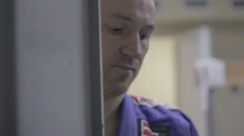 Man in a kimono open locker Stock Footage 45708857