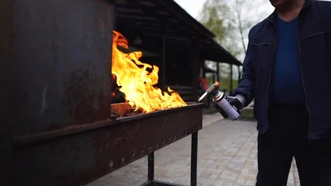 A man kindles a brazier Stockbeeldmateriaal 104410279