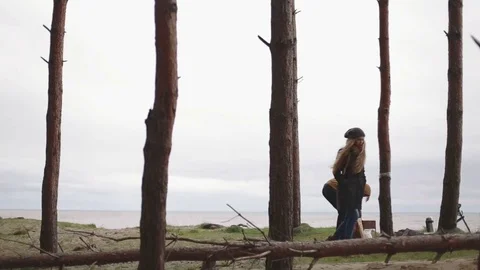 Man kindles coals in the brazier forest and sea hd woman goes out Stock Footage 70772596