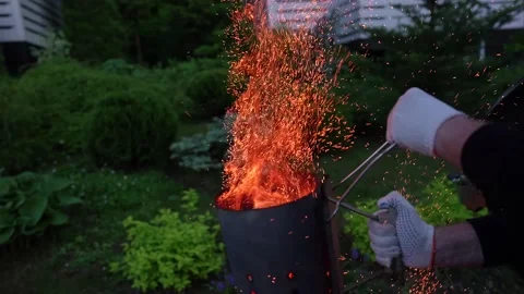 A man kindles coals in the grill  Stock Footage 160090933