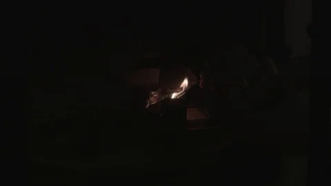 A man is kindling a fireplace Stock Footage 74244232