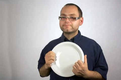 Man with kitchen accessories on white Stock Photos