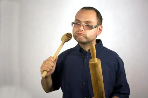 Man with kitchen accessories on white Stock Photos