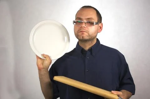 Man with kitchen accessories on white Stock Photos