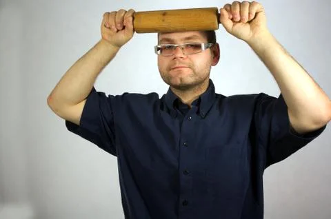 Man with kitchen accessories on white Stock Photos