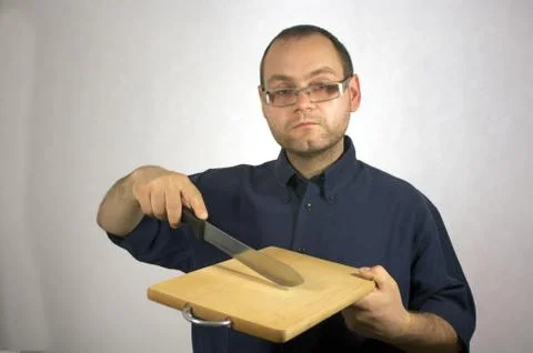 Man with kitchen accessories on white Stock Photos