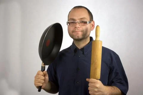 Man with kitchen accessories on white Stock Photos