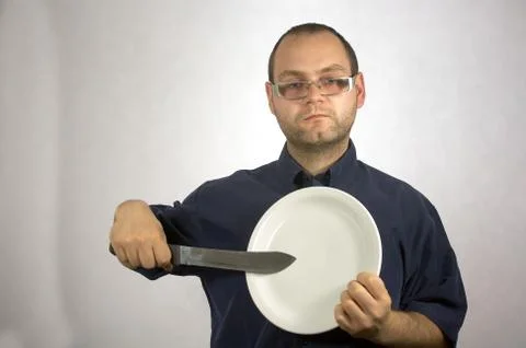 Man with kitchen accessories on white Stock Photos