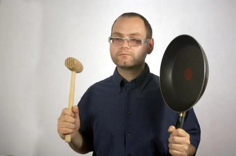 Man with kitchen accessories on white Stock Photos