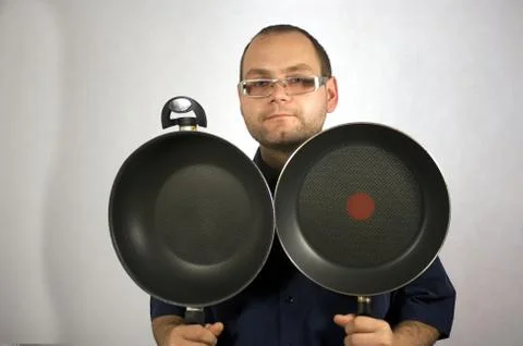 Man with kitchen accessories on white Stock Photos