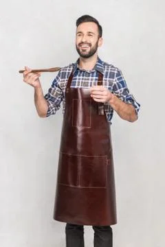 A man in a kitchen apron Stock Photos