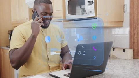 Man in kitchen on call, switching speaking, typing, charts appearing on laptop Stock Footage 333132233