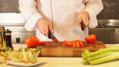 Man in kitchen chopping vegetables. Stock Footage 87667392