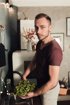 Man in the kitchen. Cooking time. Rustic color lifestyle photo. People and Stock Photos