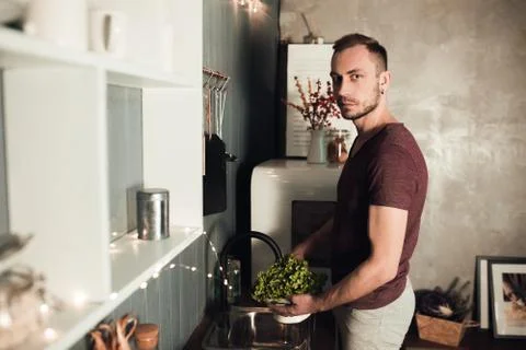 Man in the kitchen. Cooking time. Rustic color lifestyle photo. People and Stock Photos