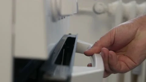 A Man in the Kitchen Opens the Stove Door and Rotates the Gas Button Increasing Stock Footage 218585336