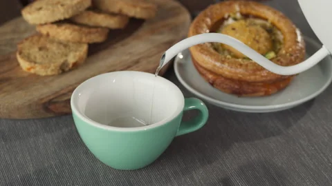 Man in the kitchen pouring a mug of hot filtered coffee from pot. Having Stock Footage 140523018