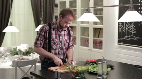 The man in the kitchen preparing salad Stock Footage 62795857