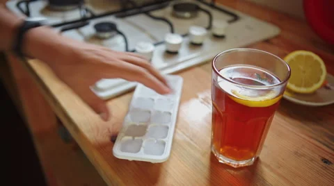 Man in the kitchen preparing tea with ice Stock Footage 66836041