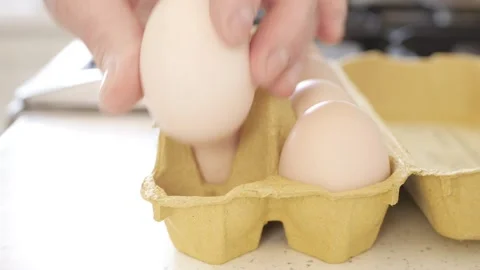 Man in the Kitchen Putting Few Fresh Eggs with Hand in a Box. Stock Footage 321705405